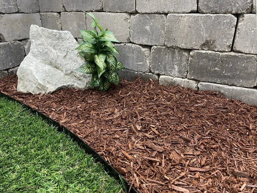 Annual mulch refresh maintaining proper depth in North Idaho ornamental beds