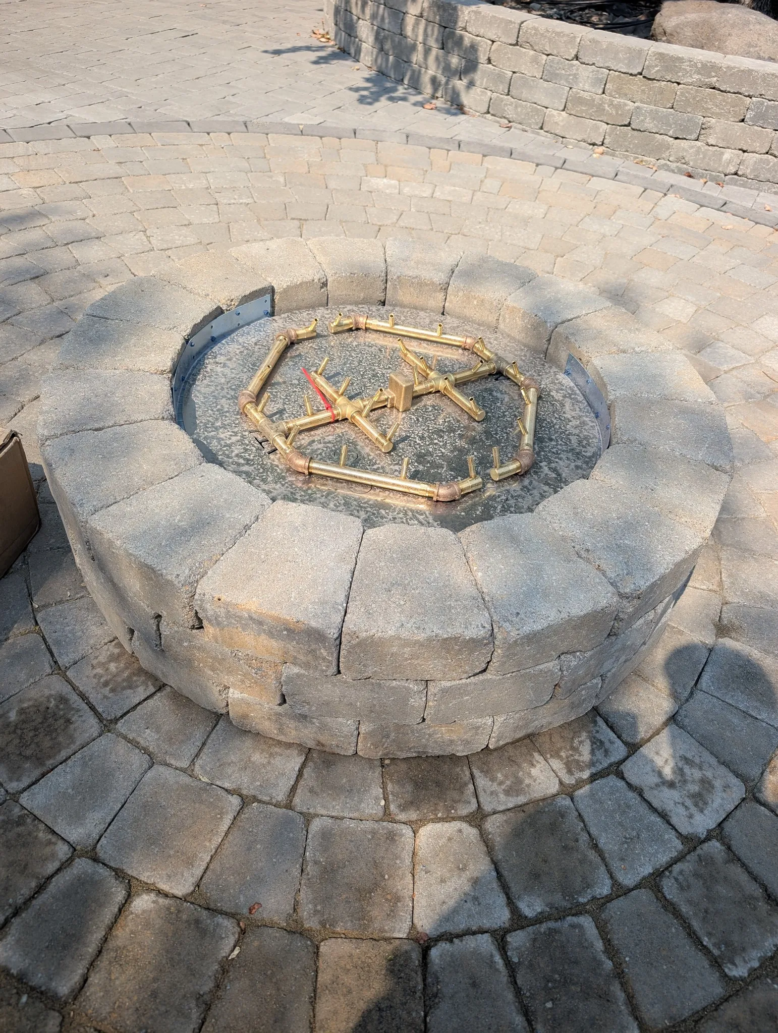 Outdoor fire feature construction for year-round patio living featuring fire feature masonry integration for durable outdoor gathering space in Post Falls, Coeur d'Alene, and North Idaho