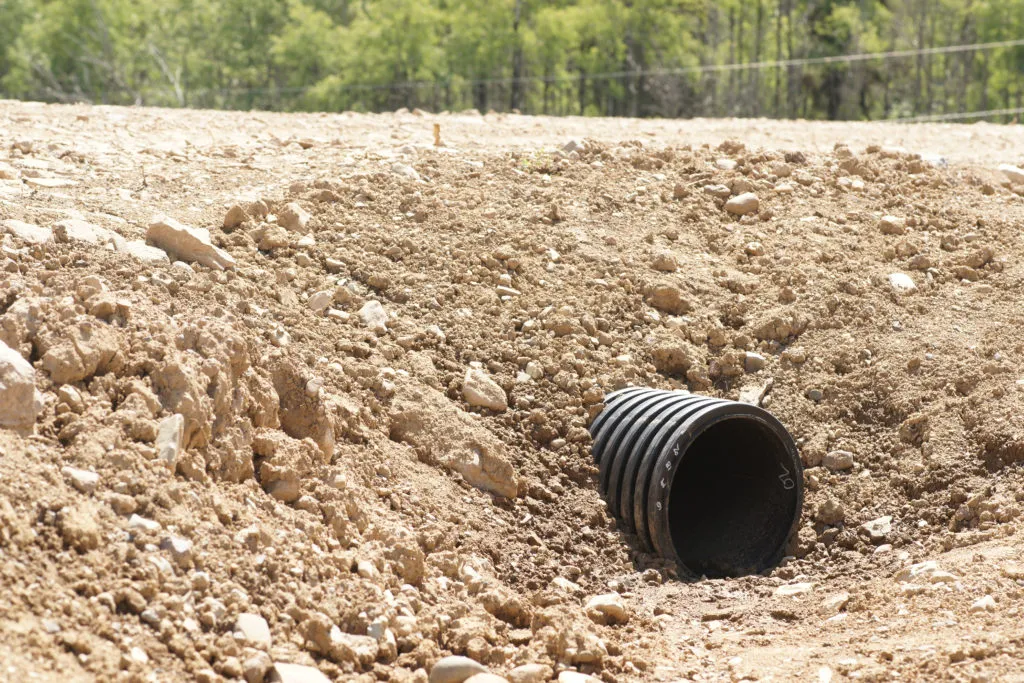 Culvert and creek crossing installation with engineered drainage flow control featuring culvert flowline setup with inlet and outlet stabilization in Post Falls, Coeur d'Alene, and North Idaho