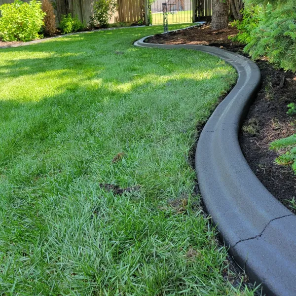 Custom hardscaping installation with stone and concrete elements featuring concrete curbing profile work for long-term bed separation in Post Falls, Coeur d'Alene, and North Idaho, gallery view 1