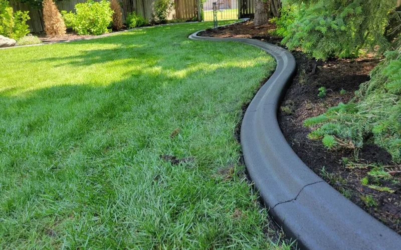 Custom hardscaping installation with stone and concrete elements featuring concrete curbing profile work for long-term bed separation in Post Falls, Coeur d'Alene, and North Idaho, gallery view 2