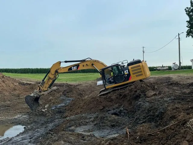 Excavation and grading work for site preparation featuring pond basin shaping and water feature earthwork in Post Falls, Coeur d'Alene, and North Idaho