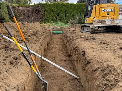 Excavation and grading work for site preparation featuring utility trench alignment and depth-controlled excavation in Post Falls, Coeur d'Alene, and North Idaho