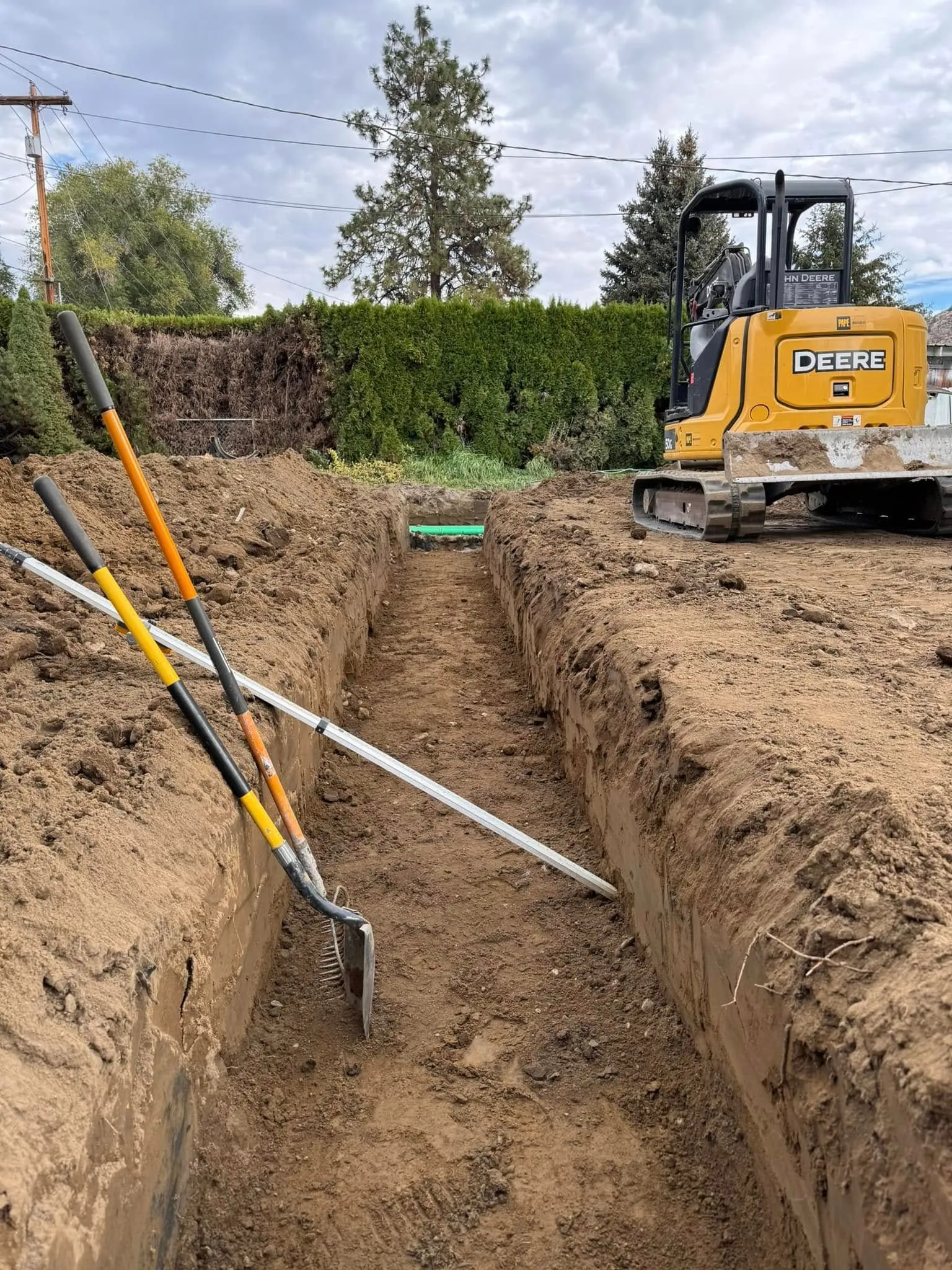 Excavation and grading work for site preparation featuring utility trench alignment and depth-controlled excavation in Post Falls, Coeur d'Alene, and North Idaho