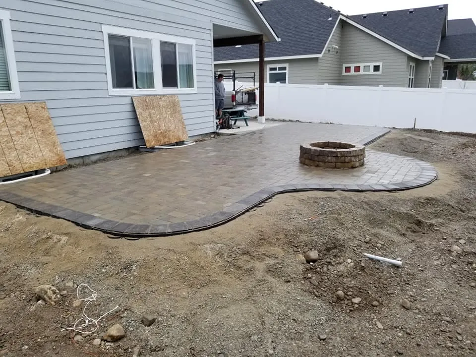 Outdoor fire feature construction for year-round patio living featuring fire feature masonry integration for durable outdoor gathering space in Post Falls, Coeur d'Alene, and North Idaho