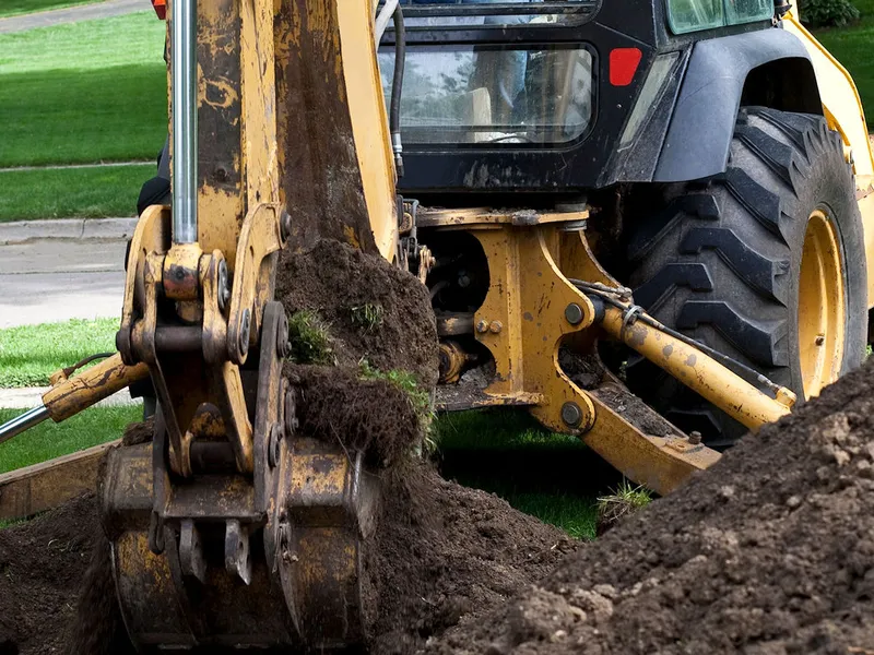 Excavation and grading work for site preparation featuring pond basin shaping and water feature earthwork in Post Falls, Coeur d'Alene, and North Idaho
