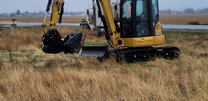 Excavator in field